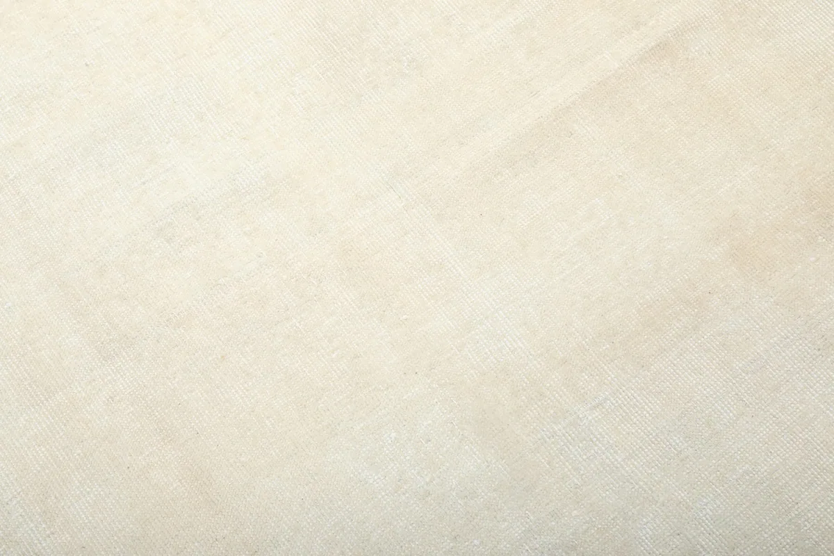 Close-up of the low wool pile, revealing the natural fiber and hand-knotted construction.