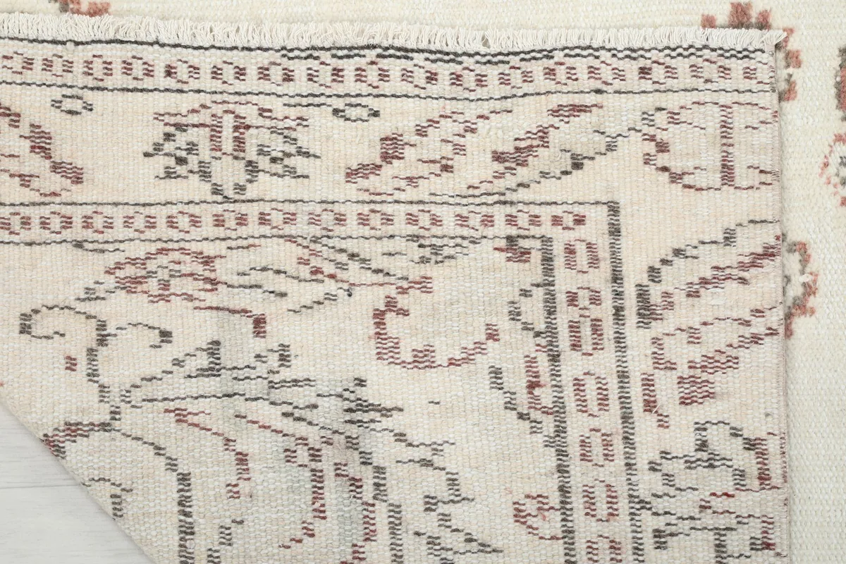 View of the rug's reverse side, revealing the cotton foundation and knotting detail.