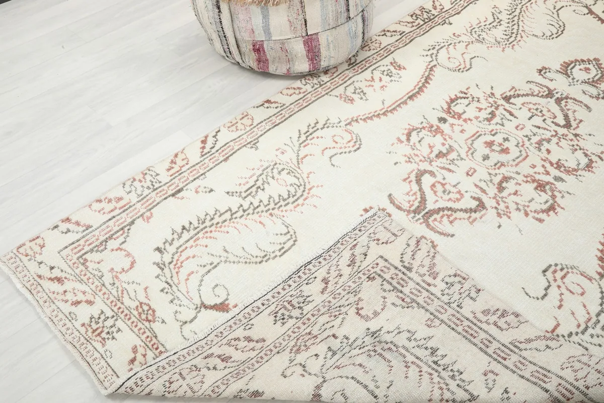 Folded corner of the rug, showing the reverse side and the hand-knotted construction.