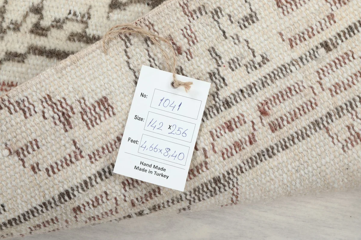 Close-up of the product tag attached to the rug, displaying its size and origin.