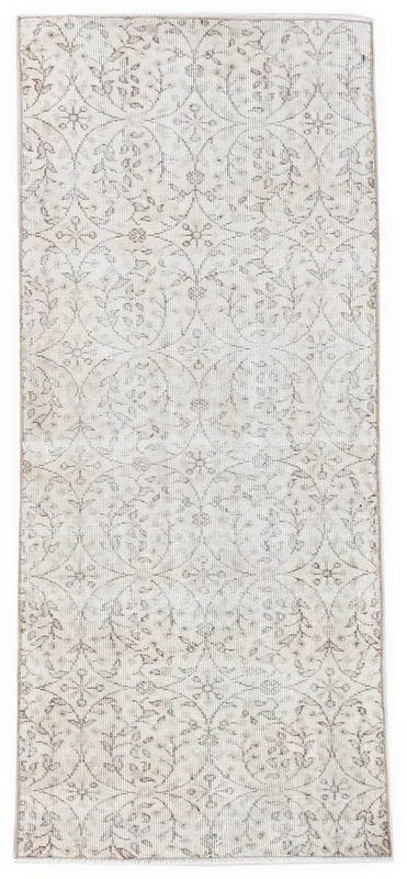 Full overhead view of the 2'7" x 6'4" cream and tan floral vintage Anatolian runner rug.