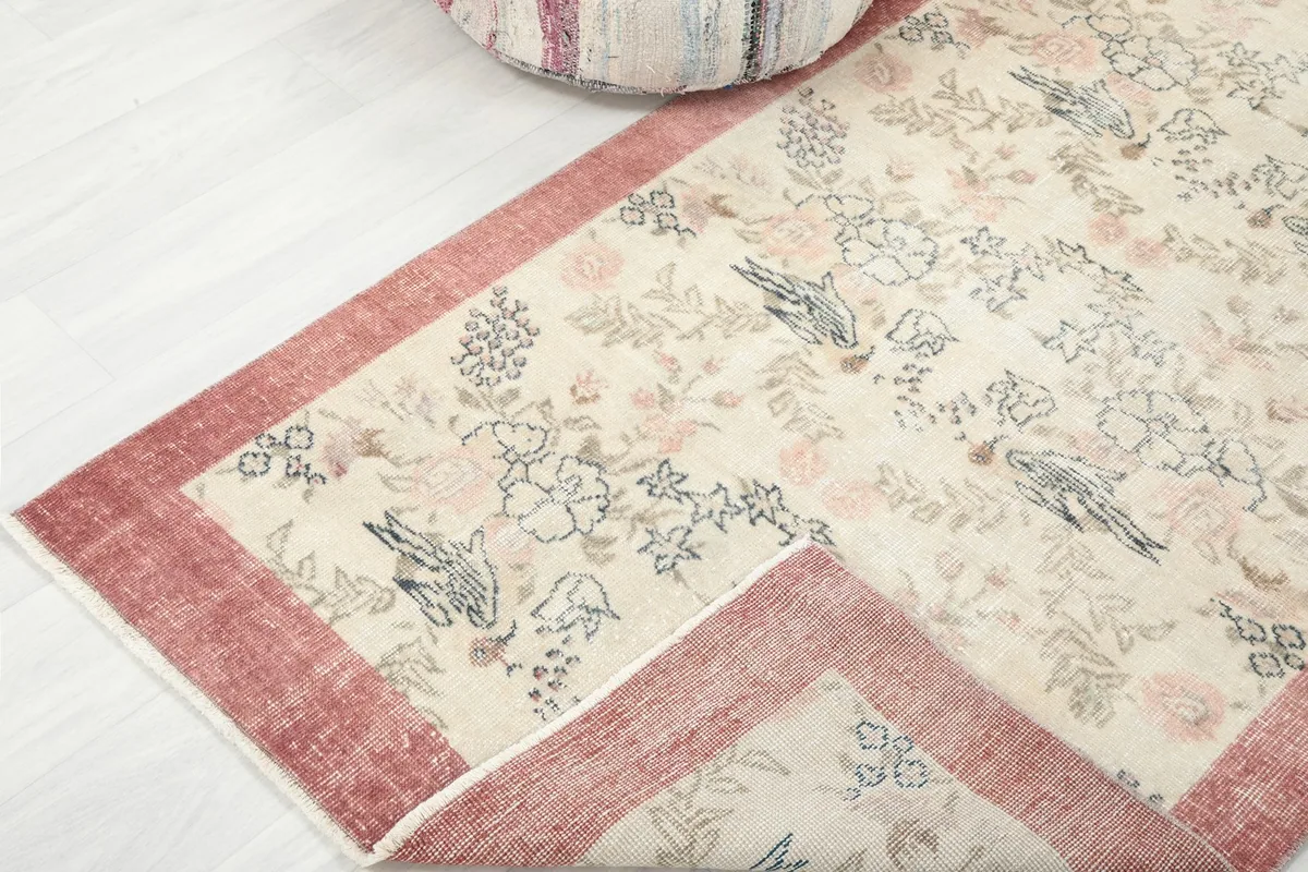 Folded corner of the rug, revealing the wool pile and cotton foundation construction