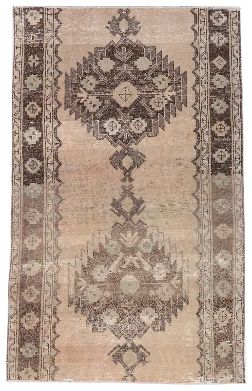 Full overhead view of the tan and brown geometric vintage Anatolian rug.