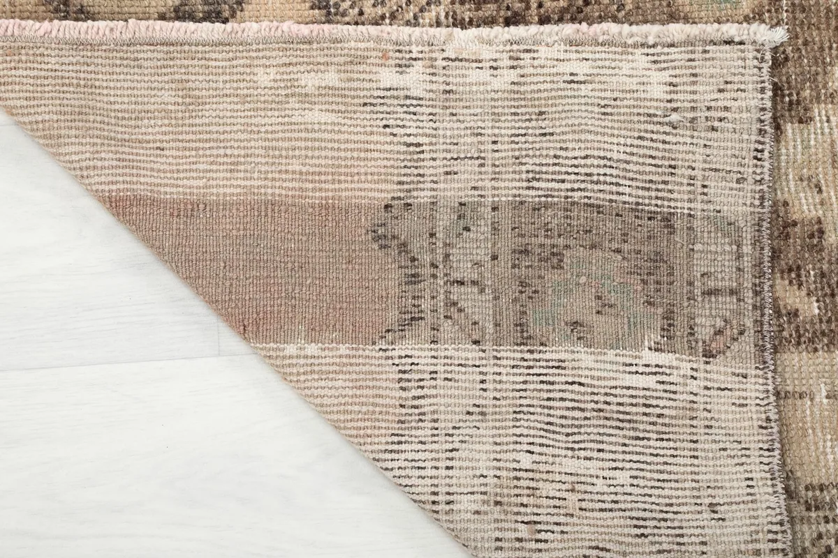 Underside of the rug, revealing the hand-knotted cotton foundation.