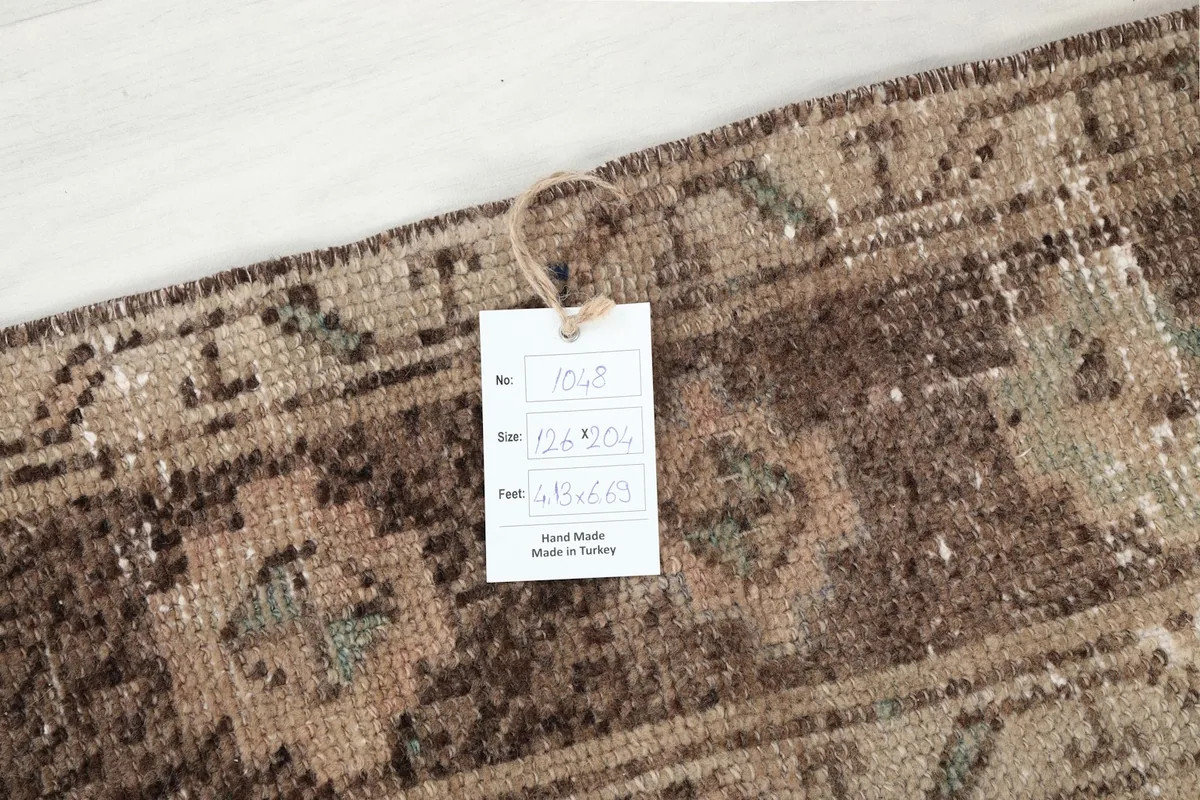 Close-up of the rug's surface with a product tag displaying size and origin.