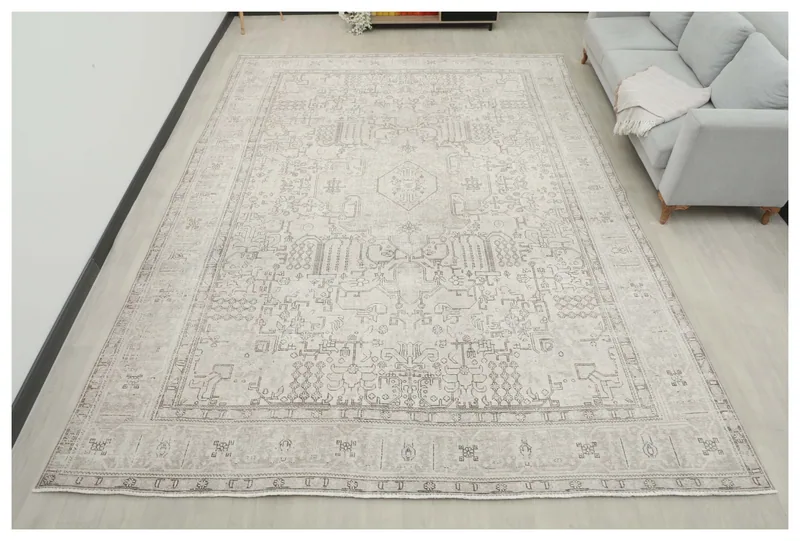 Full overhead view of the ivory and gray vintage Persian area rug.