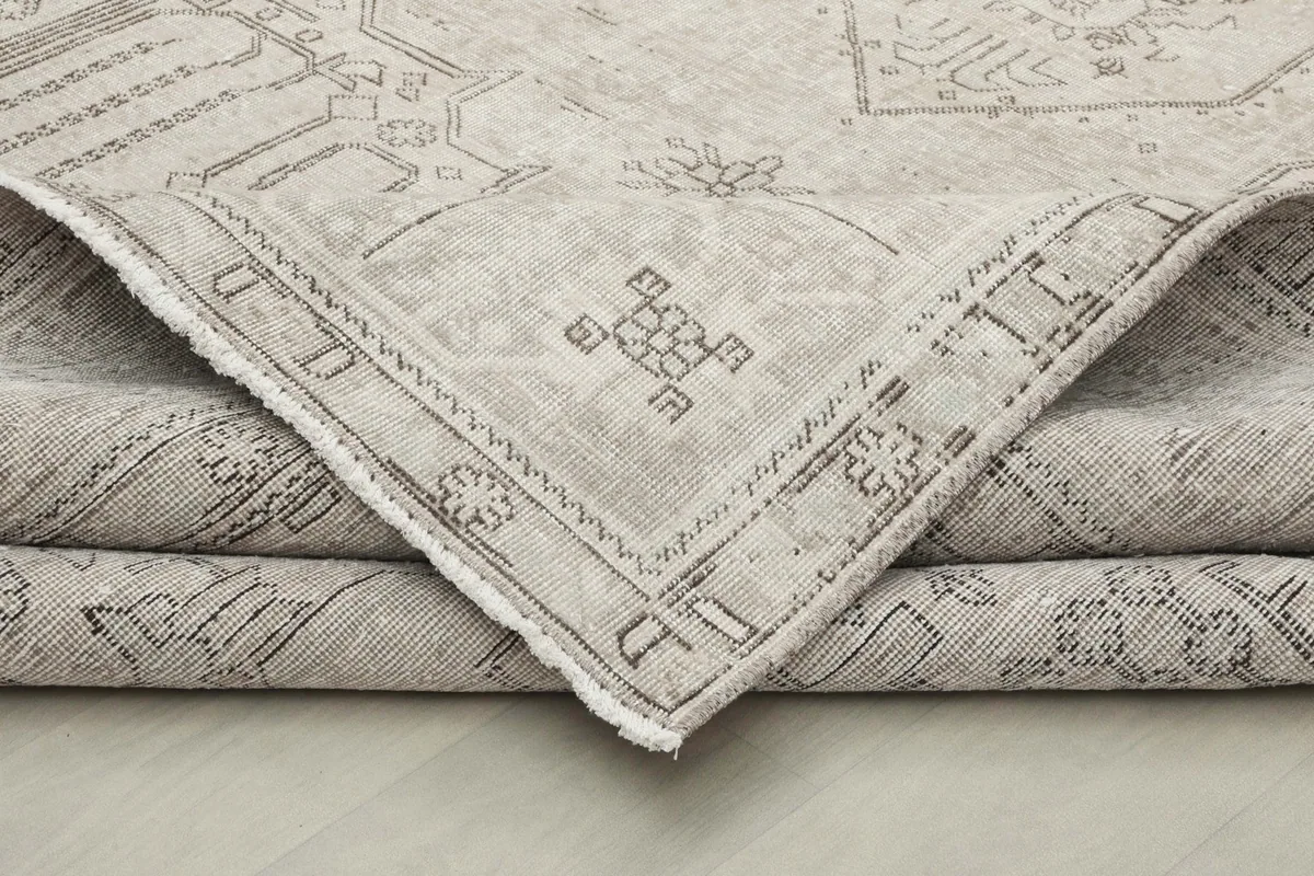 Folded corner of the rug, highlighting the thickness and hand-knotted construction.