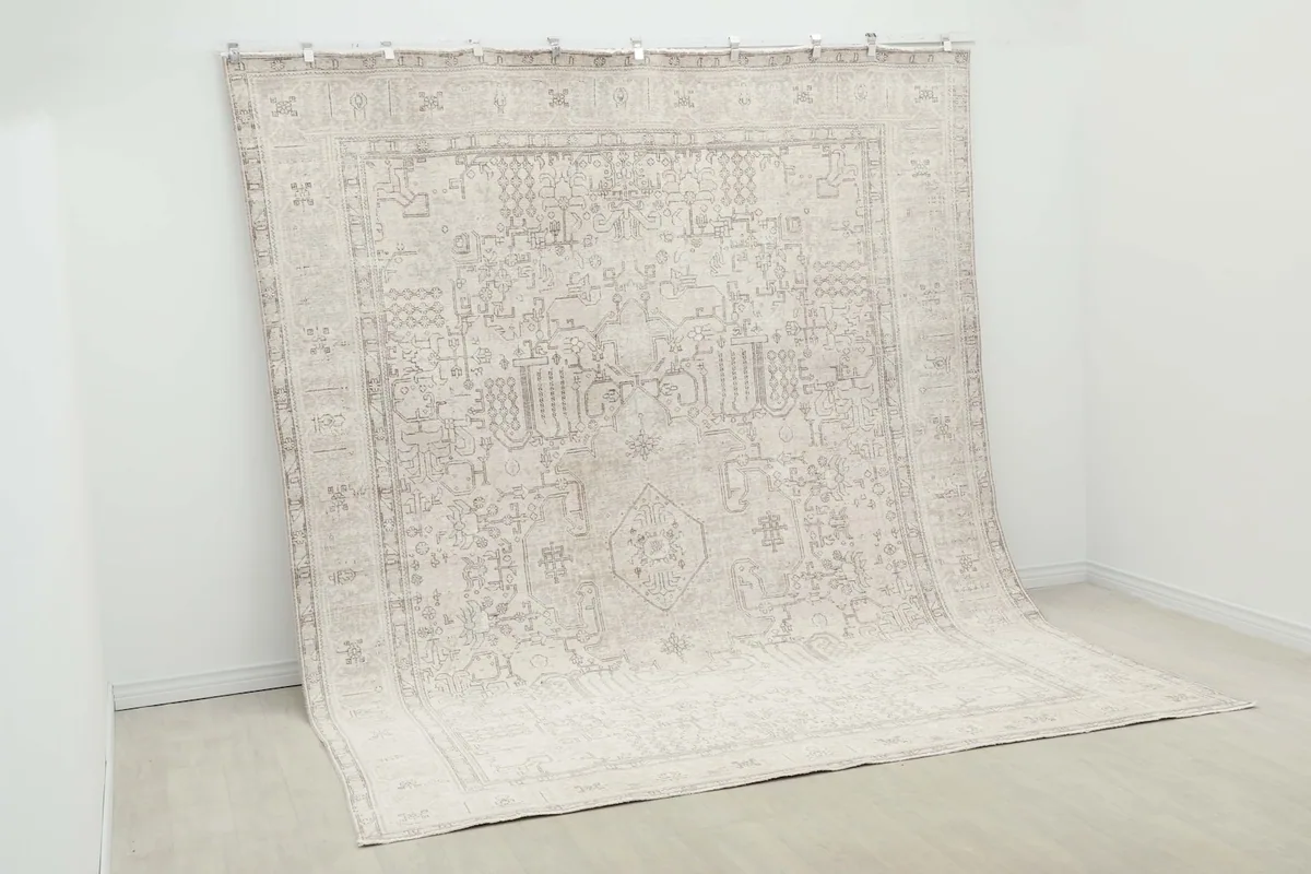 Angled view of the rug hanging, demonstrating its drape and overall appearance.