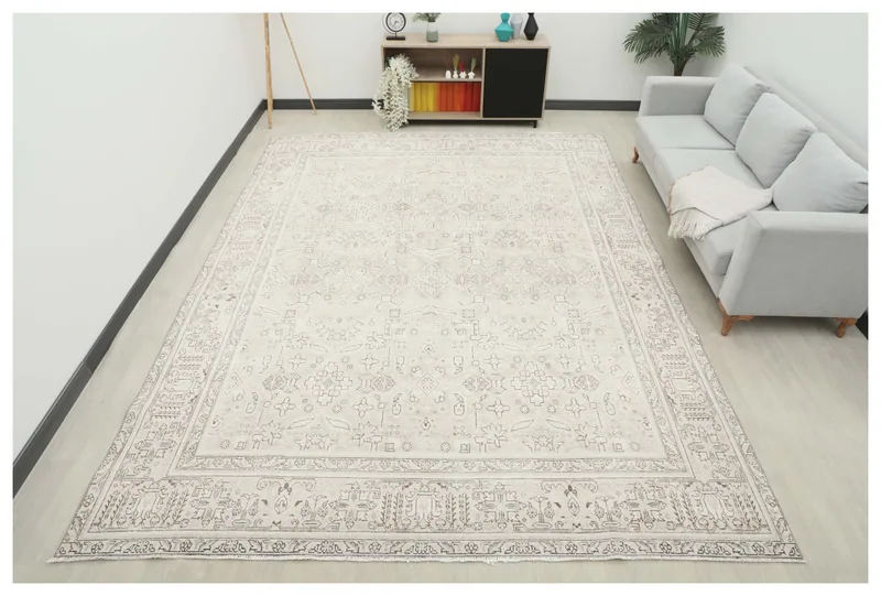 Full overhead view of the ivory geometric Persian rug on a white background.