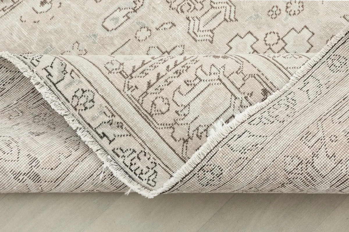 Another view of the rug folded, revealing the intricate knotting on the back.