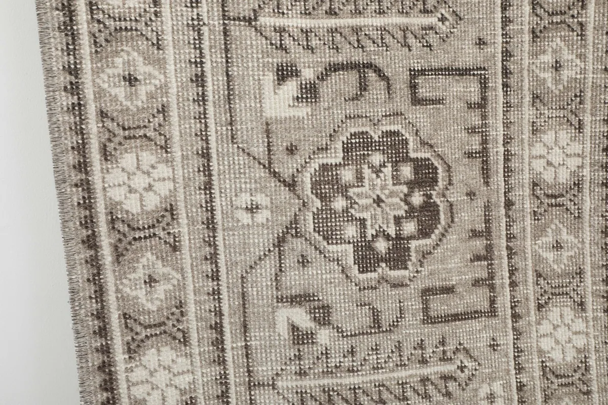 Close-up detail of a specific geometric and floral element within the rug's border
