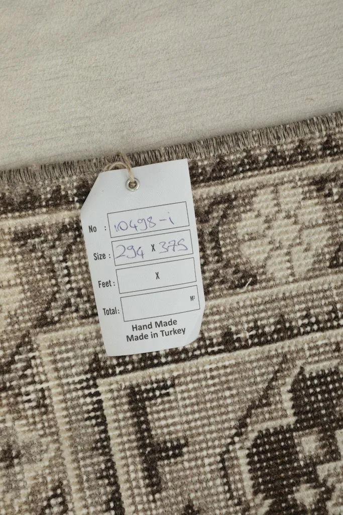 Close-up of a tag on the rug, showing size and origin details