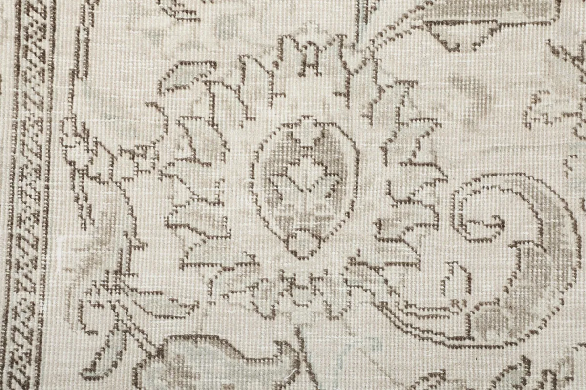 Detailed shot of a specific floral medallion motif and surrounding patterns within the rug
