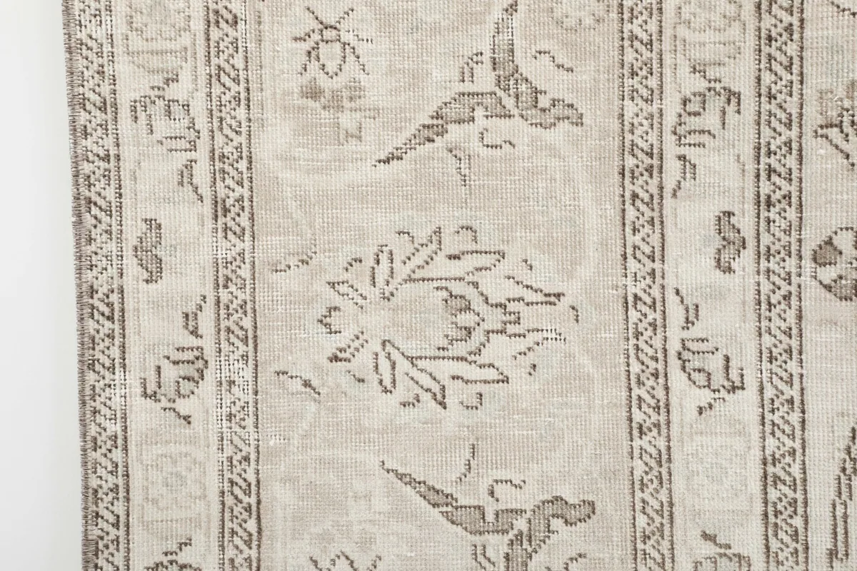 Close-up of a border section, revealing smaller decorative motifs and the fringe detail