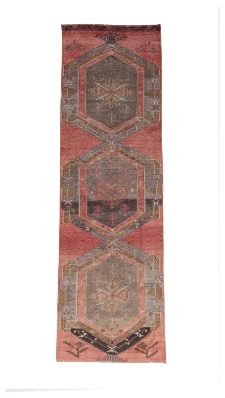 Full top view of the vintage rust and gray geometric Anatolian runner rug on a white background.