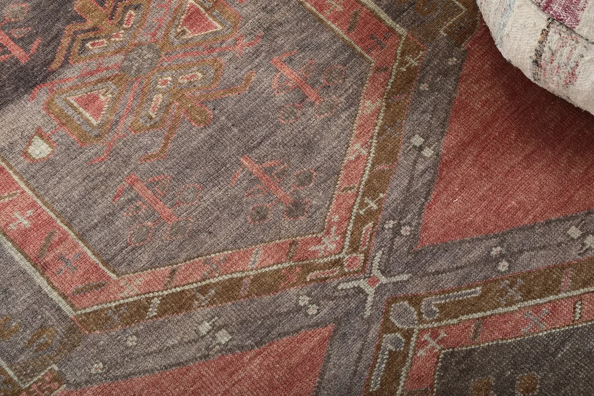 Detailed view of the rug's hand-knotted texture and intricate geometric motifs.