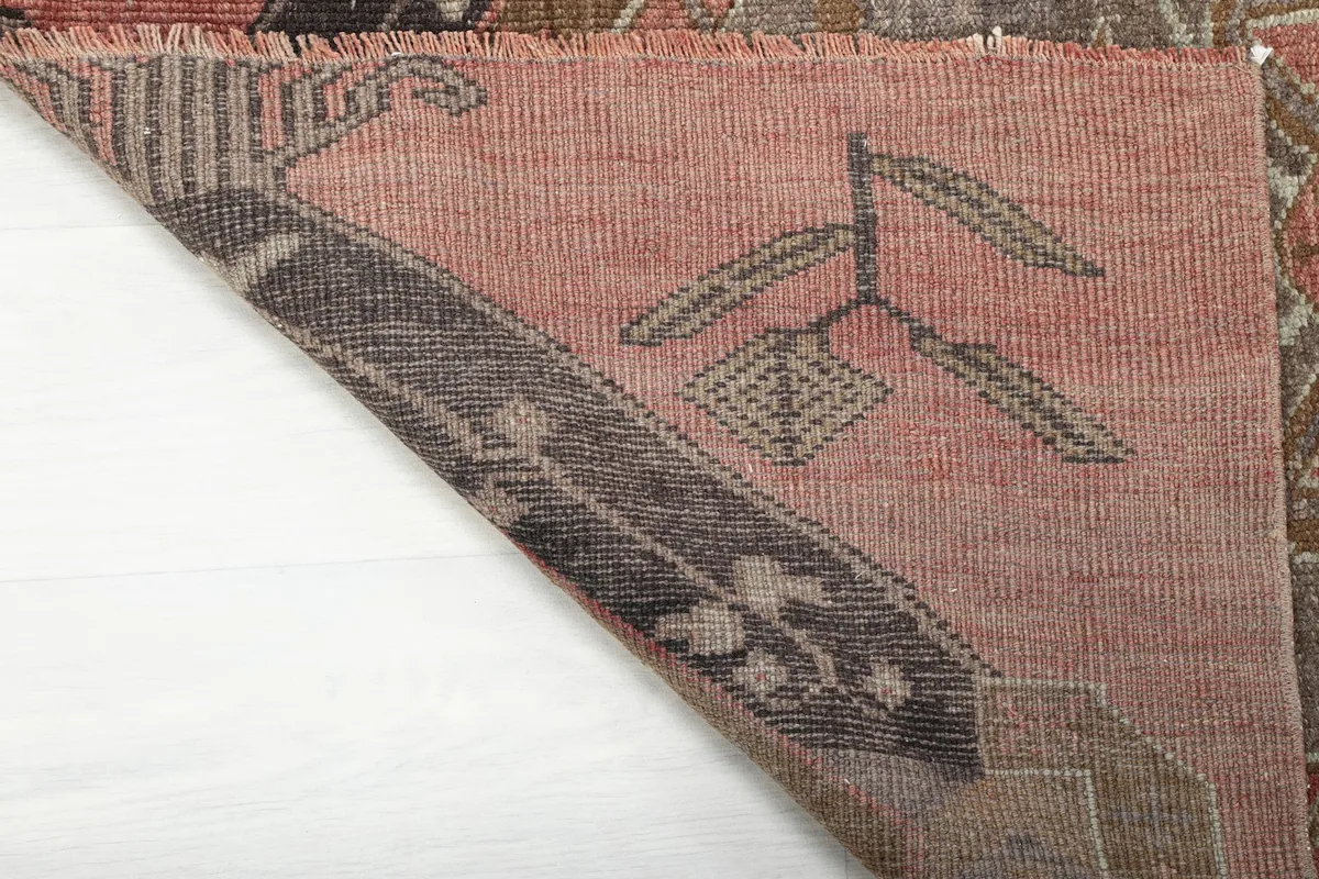 Close-up of the rug's reverse side, revealing the hand-knotted construction and wool pile on cotton foundation.