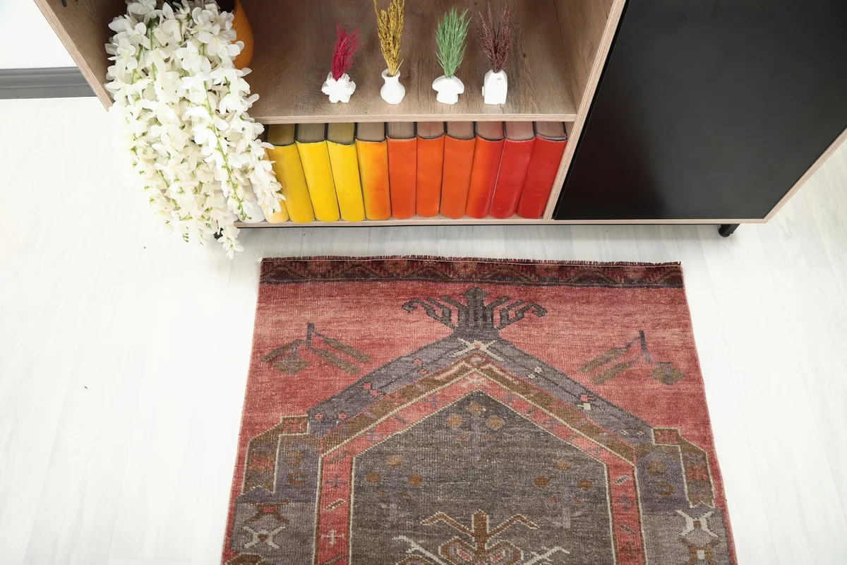 Overhead view of one end of the rug, showing the geometric design and color variation.