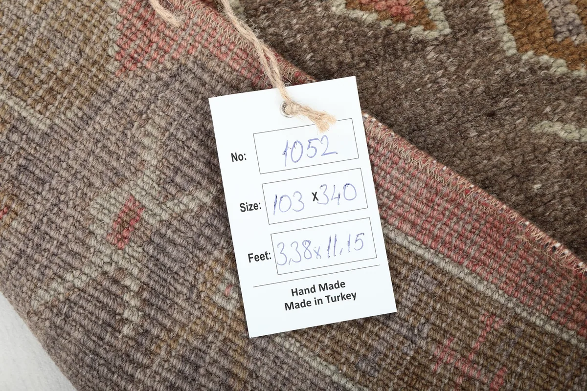 Tag showing the rug's item number, size in centimeters and feet, and origin: Hand Made in Turkey.