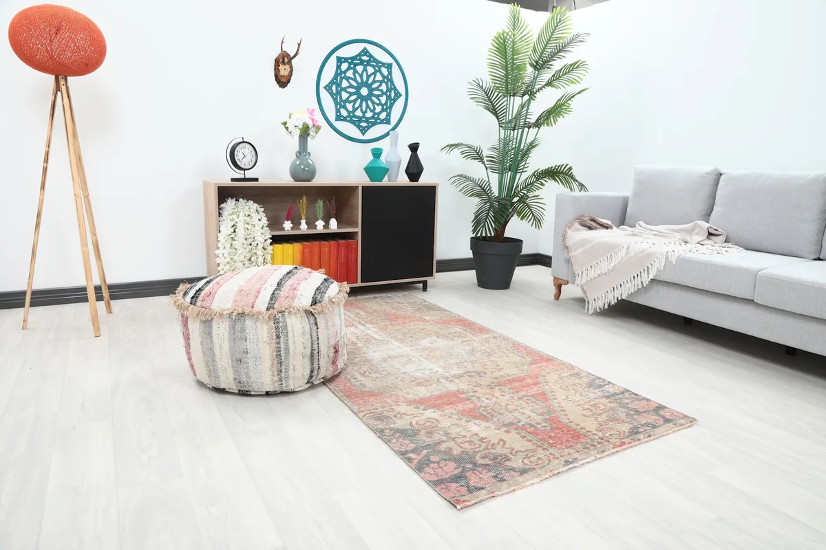 Area rug in a living room, showing its placement next to a sofa and ottoman