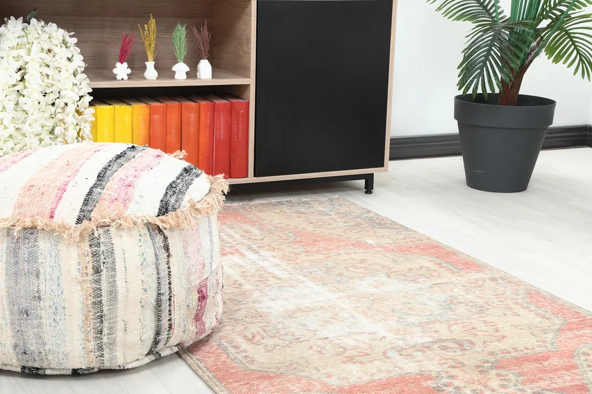 Close-up view of the rug in a room setting, highlighting its colors and texture