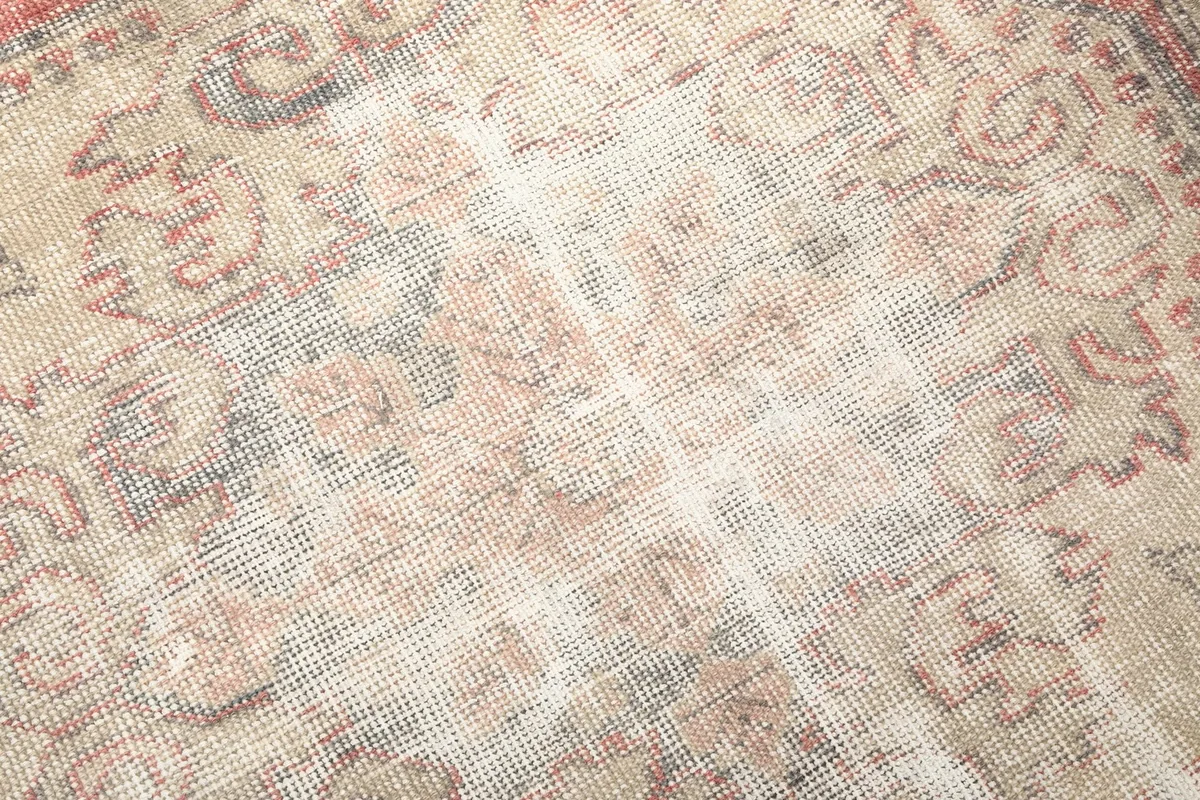 Close-up of the low wool pile and intricate knotting of the vintage rug