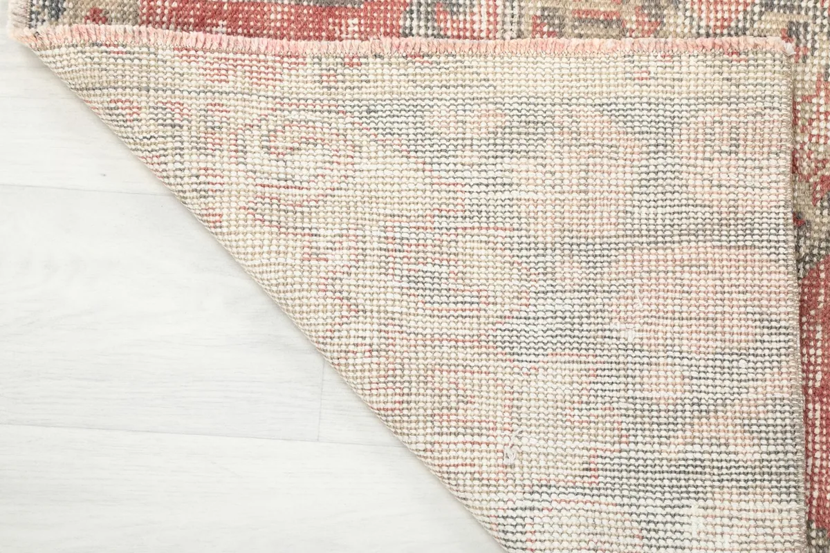 Underside of the hand-knotted rug, showing the cotton foundation