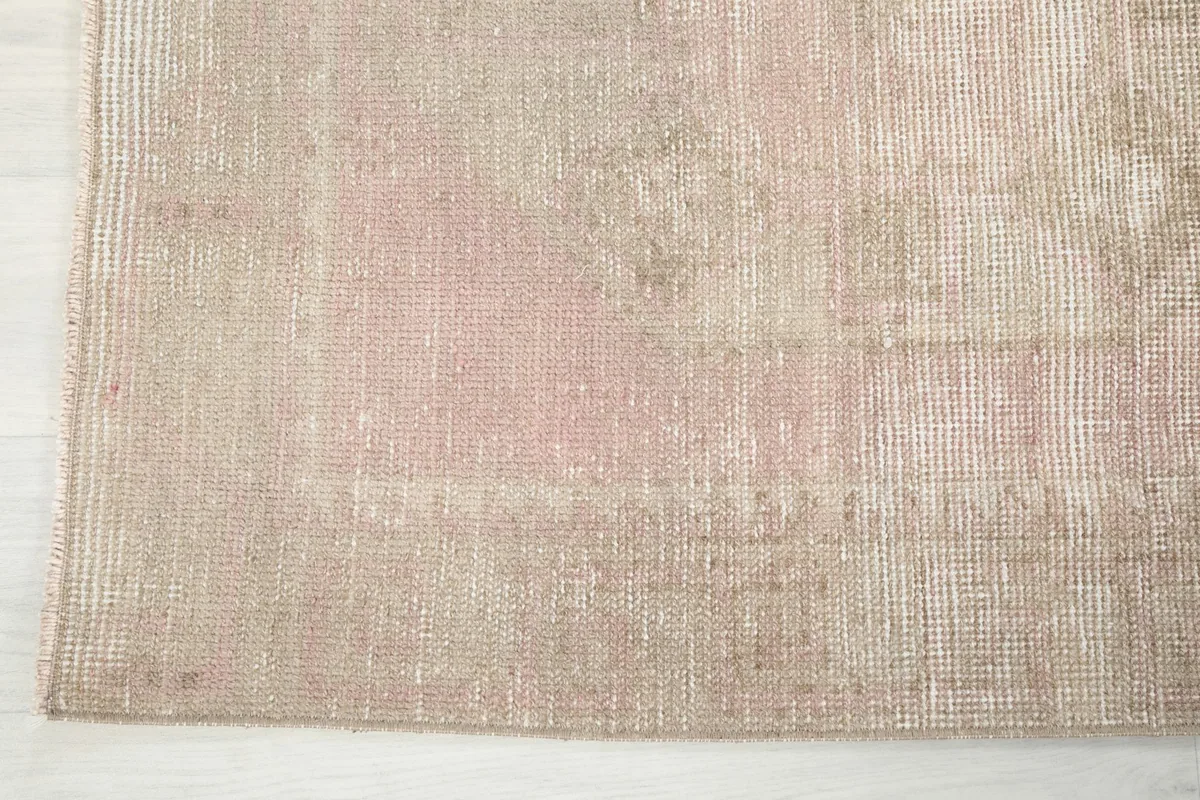 Edge detail of the runner rug, showing the subtle color variations and hand-knotted construction