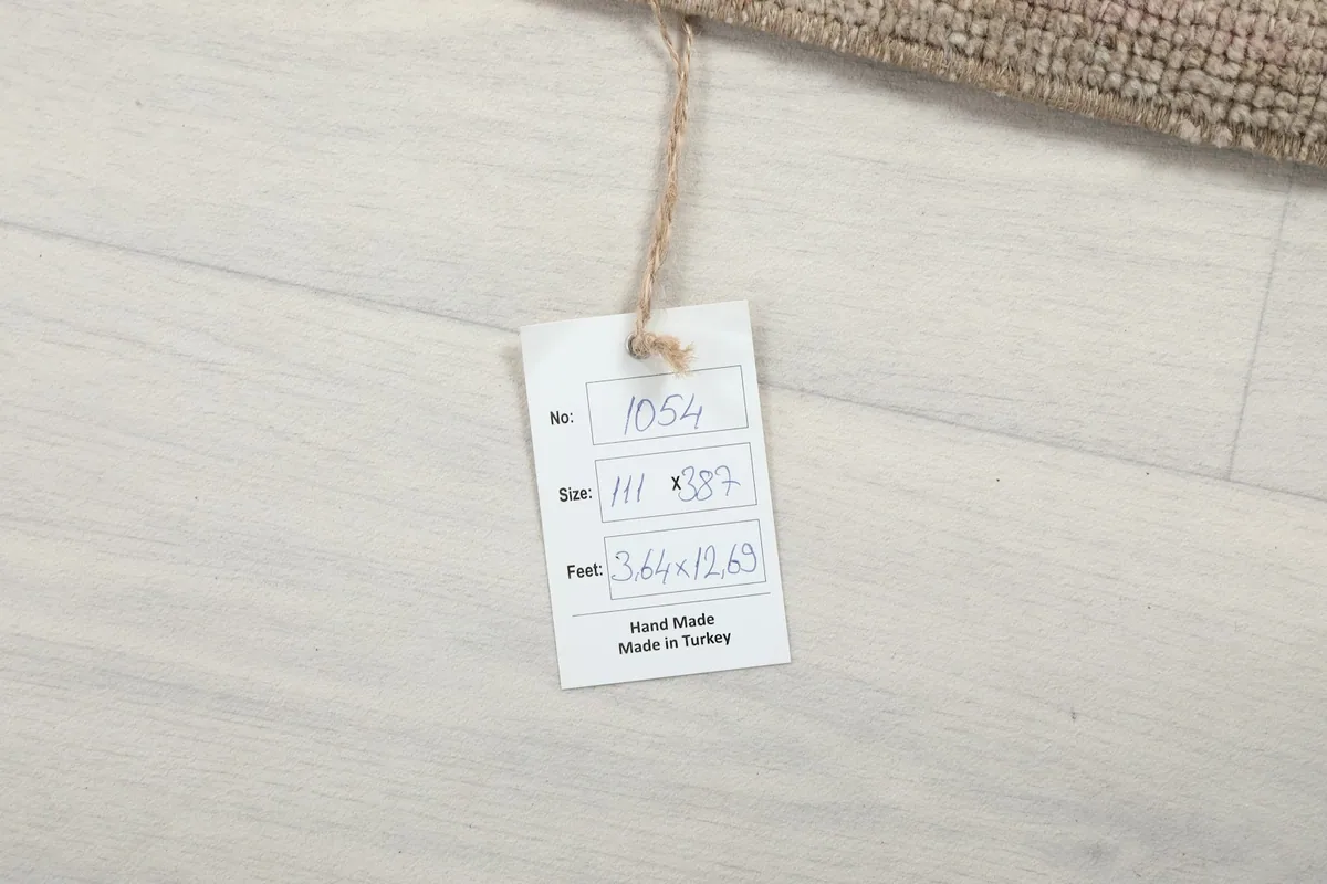 Product tag for the hand-knotted vintage rug, showing size and origin details