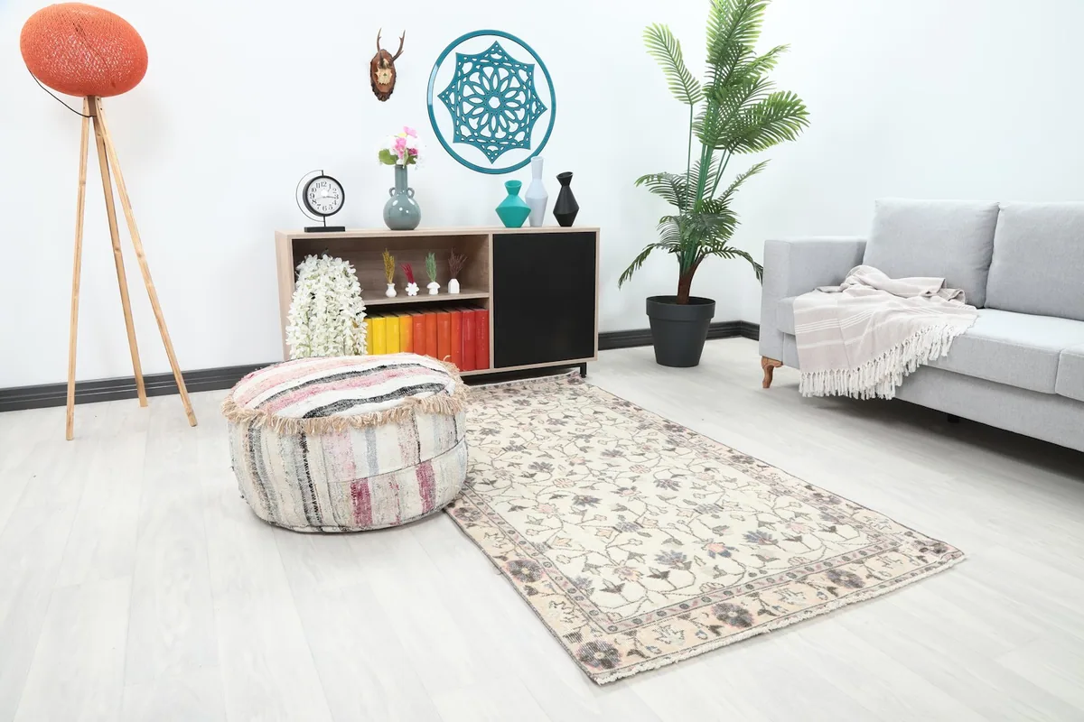 Angle view of the ivory floral vintage rug placed in a bright room with modern decor.