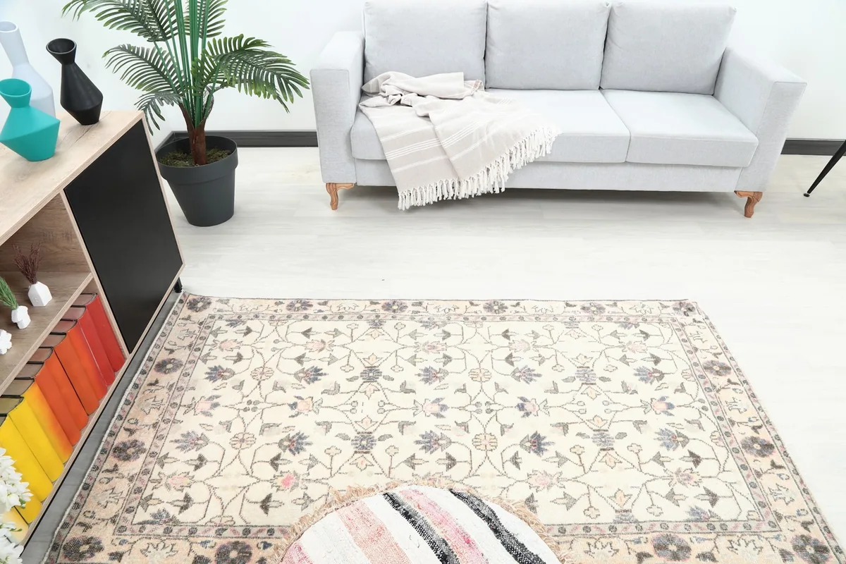 Overhead view of the rug in a room, highlighting its placement near a sofa and a plant.