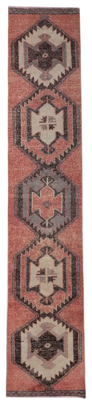 Full overhead view of the rust, gray, and charcoal geometric Anatolian runner rug on a white background.