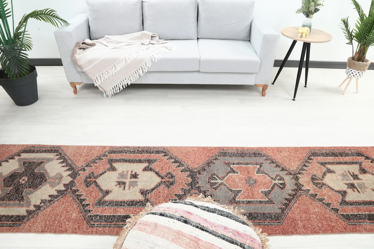 Overhead view of the runner rug in a room setting, focusing on the central geometric motifs and surrounding decor.
