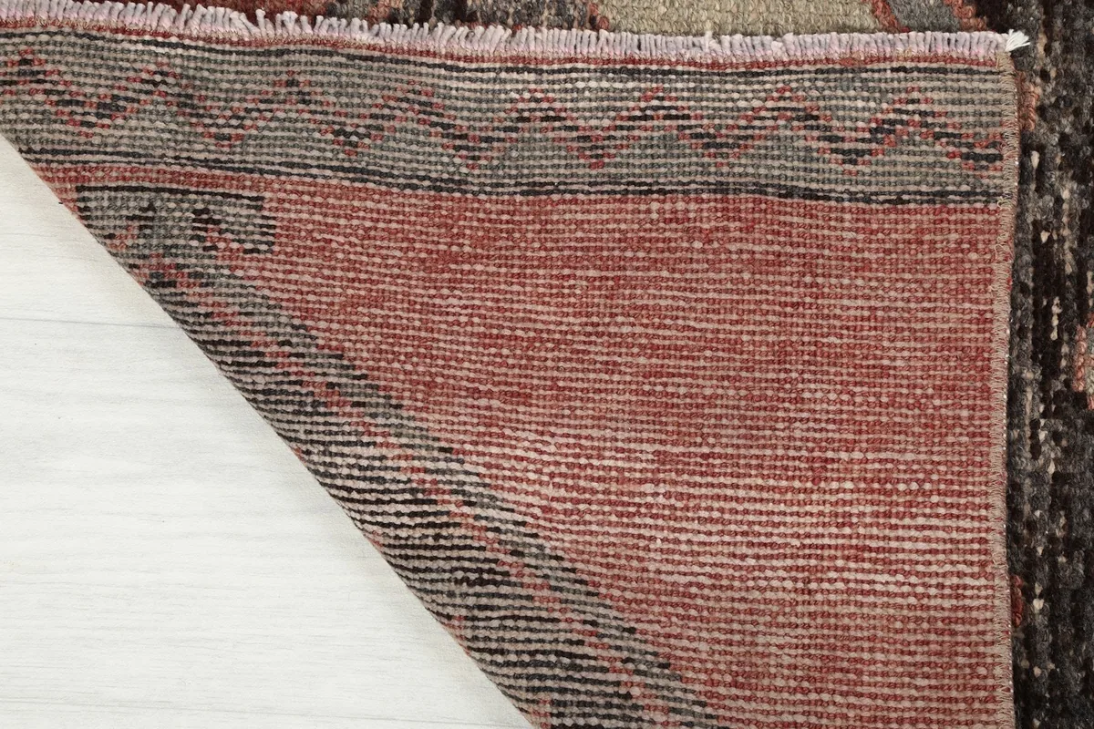 Close-up of the back of the rug, showing the dense hand-knotting and cotton foundation structure.