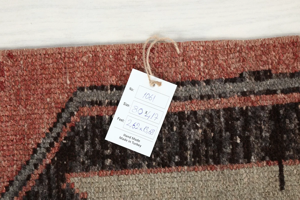 Close-up of the product tag attached to the rug, displaying information such as size and origin.