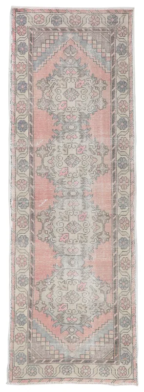 Full top view of the 3'1" x 9'3" rose and beige geometric vintage Anatolian runner