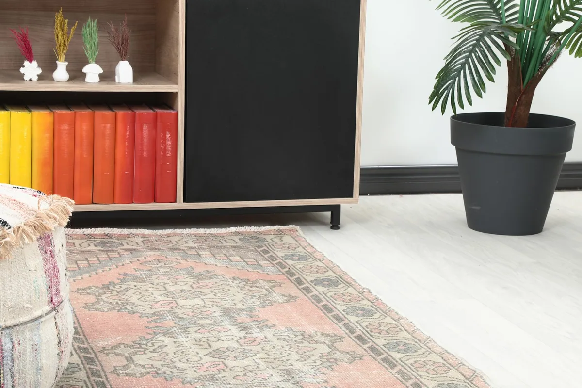 Close-up of the runner rug's end in a room, showing its colors and texture next to furniture