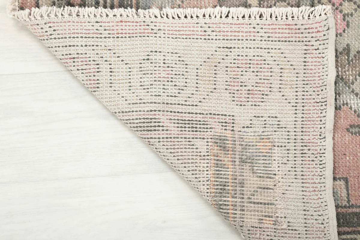 Close-up of the rug's back, revealing the intricate hand-knotted cotton foundation