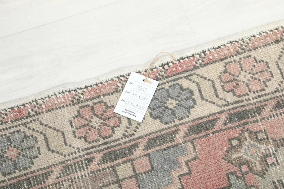Detail of the rug's corner with a product tag, showing the weave and fringe