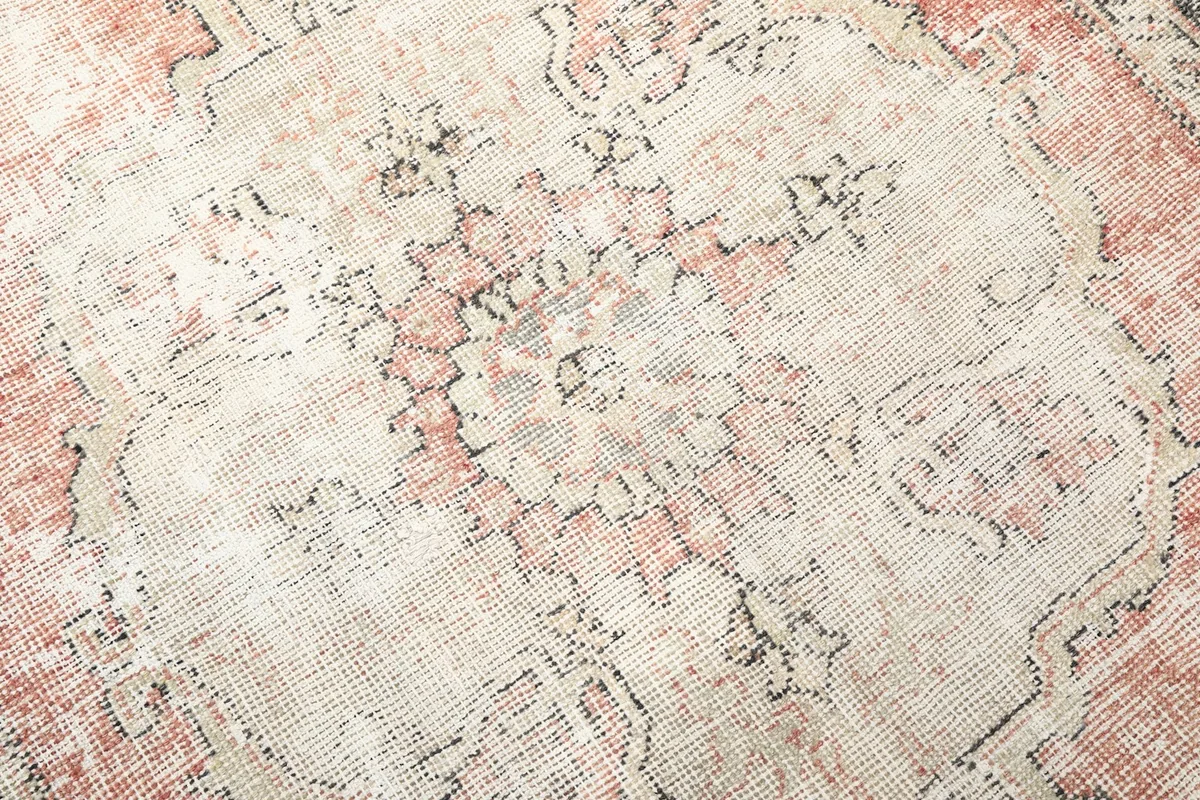 Detailed view of the wool pile texture and distressed geometric patterns.