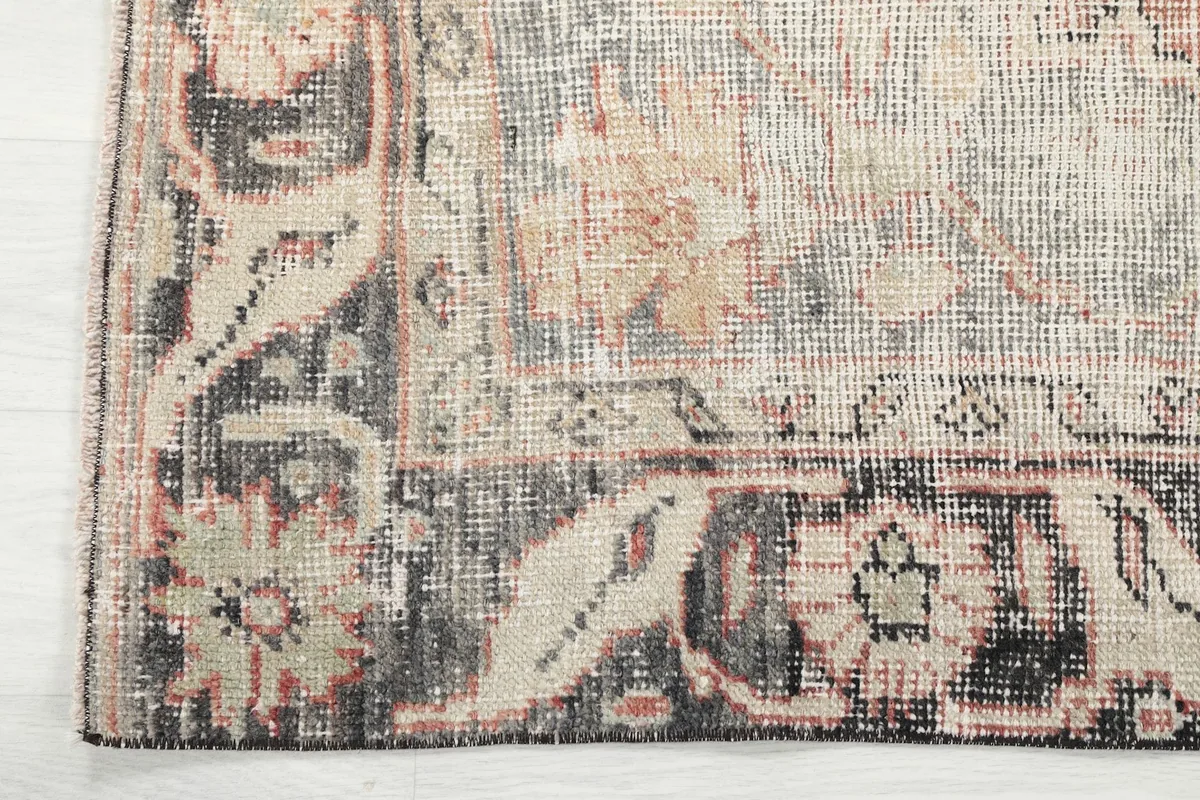 Close-up of the charcoal border with intricate geometric and floral designs.