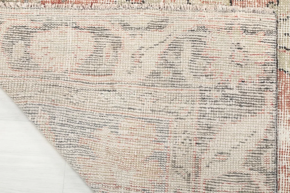 Close-up of the hand-knotted cotton foundation from the back of the rug.