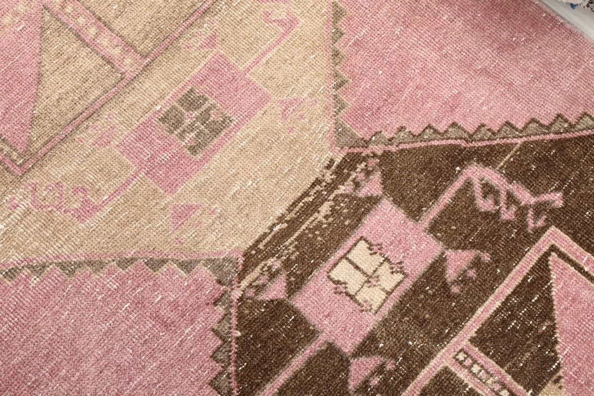 Close-up of the intricate hand-knotted patterns and color variations in the rug's pile.