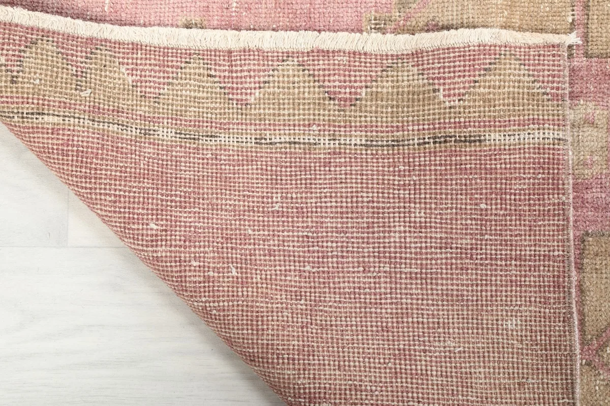 Underside of the hand-knotted rug, showing the cotton foundation and knotting structure.