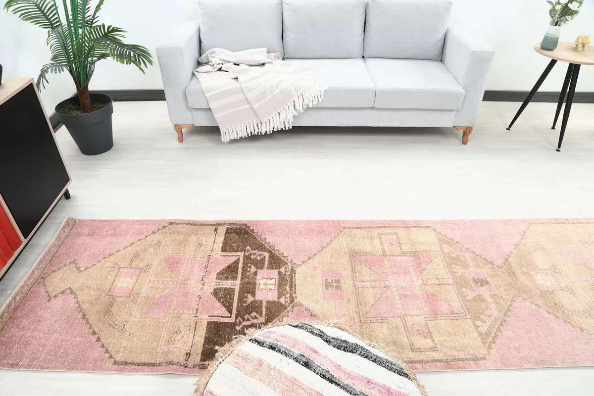 Overhead view of the vintage runner rug in a room, showing the geometric patterns and color variations.