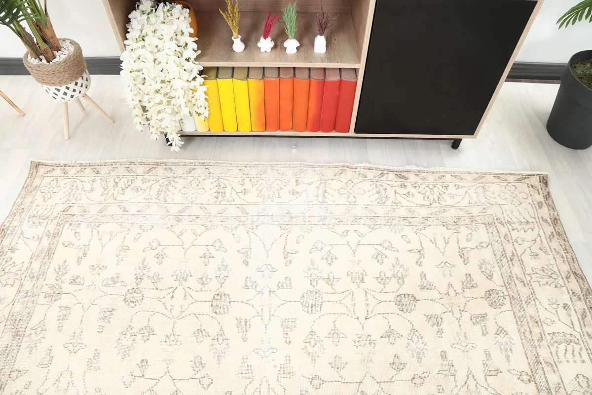 View of the rug's bottom half in a room setting, showing the border near a shelf