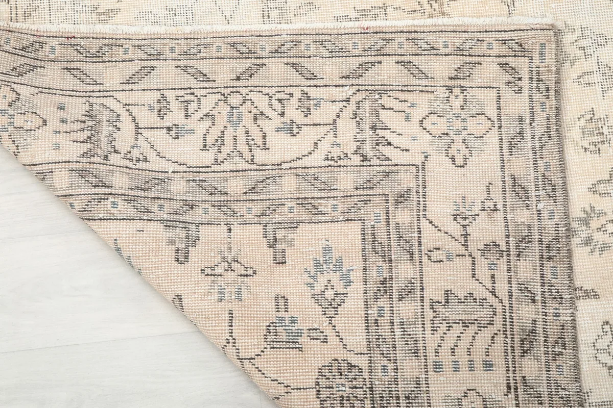 Close-up of the rug's back, revealing the hand-knotted wool on cotton foundation