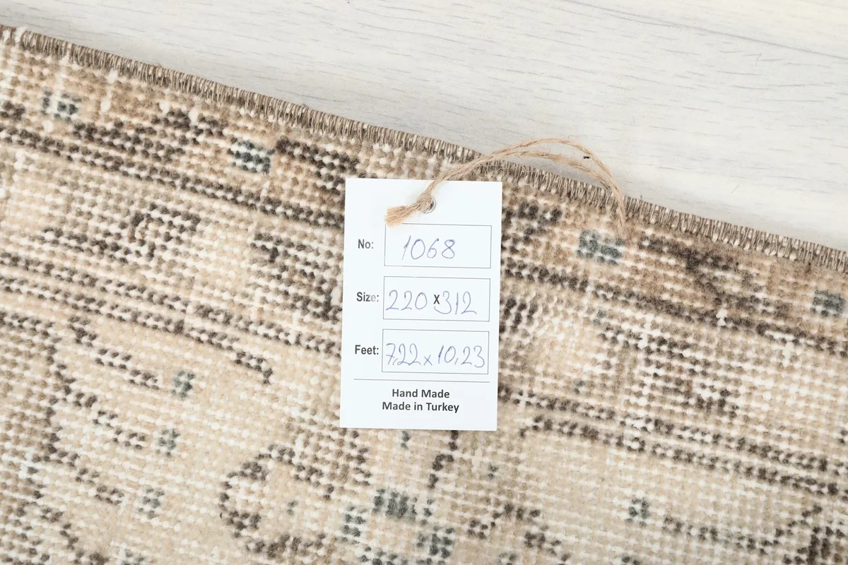 Close-up of the rug's label showing the item number, size in cm and feet, and 'Hand Made in Turkey'
