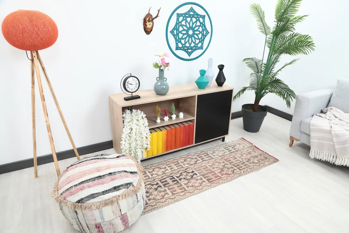 Overhead view of the runner rug in a room setting, showing its length next to a cabinet