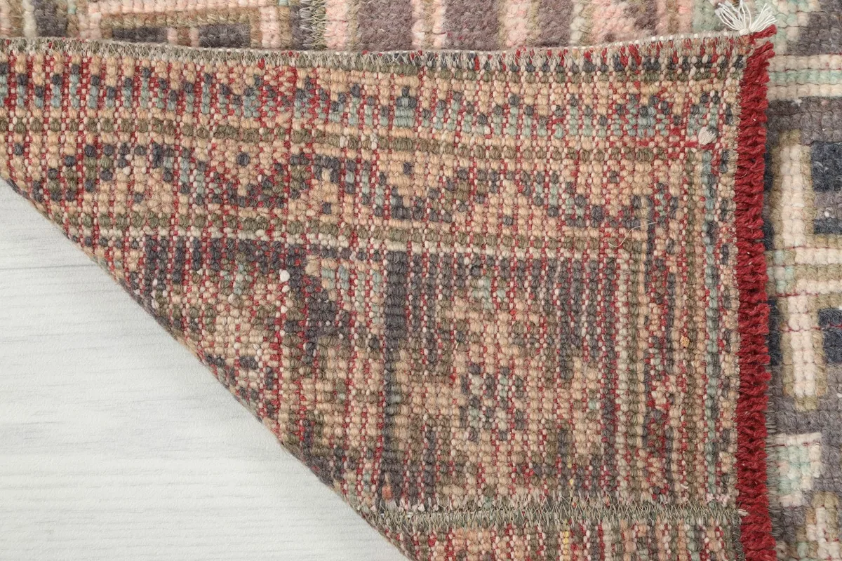 Close-up of the rug's reverse side, showing the intricate knotting and foundation